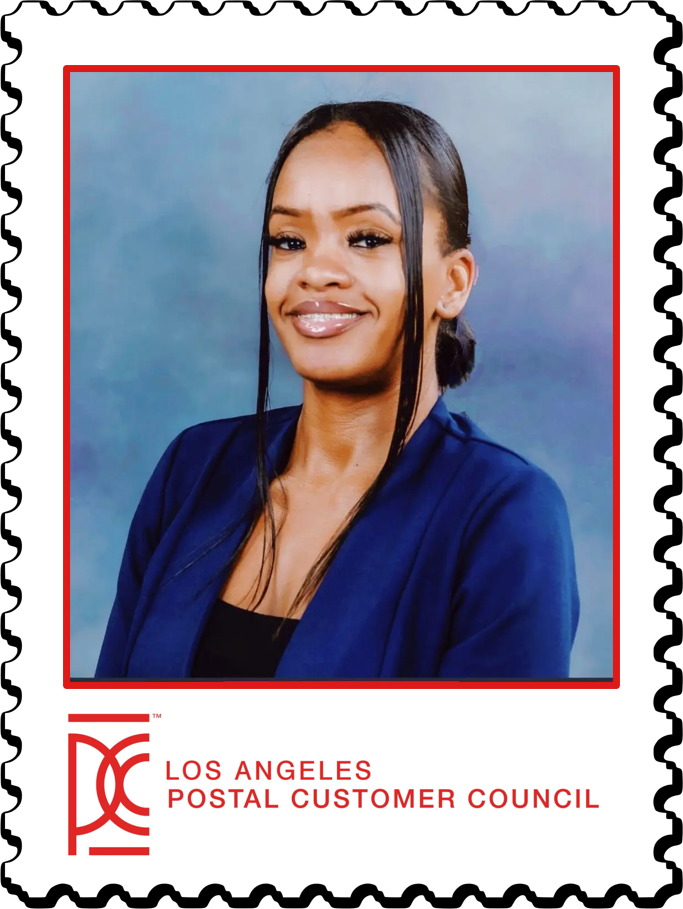 Woman smiling in blue jacket, LA Postal Customer Council.